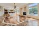 Open living area with hardwood floors and a view of the kitchen and backyard at 4327 Melrose Abbey Pl, Las Vegas, NV 89141