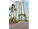 Luxury high-rise building with palm trees and a paved driveway at 2877 Paradise Rd # 104, Las Vegas, NV 89109