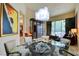 Bright dining area with a glass table, modern chairs, and large windows offering natural light at 2877 Paradise Rd # 104, Las Vegas, NV 89109