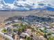 Picturesque aerial view of a neighborhood with lush trees and majestic mountains in the background at 16 Cerrito St, Blue Diamond, NV 89004