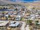 A high-angle view showing the street, homes, and the natural landscape in this beautiful small town at 16 Cerrito St, Blue Diamond, NV 89004