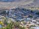 An aerial view showing the neighborhood nestled amidst mountainous terrain, capturing the town's unique setting and charm at 16 Cerrito St, Blue Diamond, NV 89004