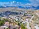 Scenic aerial view of a charming neighborhood nestled at the base of majestic mountains at 16 Cerrito St, Blue Diamond, NV 89004