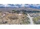 Scenic aerial view of a small desert town surrounded by mountains under a cloudy sky at 16 Cerrito St, Blue Diamond, NV 89004