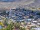 High angle aerial shot of a town and neighborhood nestled in a rural area with hills and trees at 16 Cerrito St, Blue Diamond, NV 89004