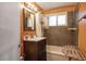 Cozy bathroom with a dark wood vanity and tiled shower at 16 Cerrito St, Blue Diamond, NV 89004