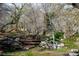 Picturesque view of a small wooden bridge over a creek in a park-like setting with trees and rock walls at 16 Cerrito St, Blue Diamond, NV 89004