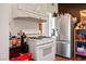 Bright kitchen featuring stainless steel refrigerator and gas range and hardwood floors at 16 Cerrito St, Blue Diamond, NV 89004