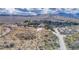 Scenic view of a desert landscape with homes in the distance, blending community living with vast natural spaces at 16 Cerrito St, Blue Diamond, NV 89004