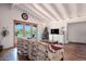 Bright living room featuring wood floors, beamed ceilings, backyard views and comfortable furniture at 16 Cerrito St, Blue Diamond, NV 89004
