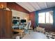 Well-lit home office with a desk, a white chair, and neutral-colored walls at 16 Cerrito St, Blue Diamond, NV 89004