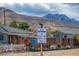 Street scene showcasing the neighborhood welcome sign and houses, creating a warm, inviting community image at 16 Cerrito St, Blue Diamond, NV 89004