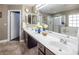 Bathroom with double vanity and large mirror at 5413 Lochmor Ave, Las Vegas, NV 89130