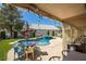 Relaxing pool area with patio furniture under covered pergola at 5413 Lochmor Ave, Las Vegas, NV 89130