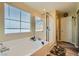 Bathroom with a large tub and walk-in shower at 6322 Highledge St, North Las Vegas, NV 89081