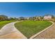 Lush community park featuring a sidewalk, green grass, mature trees, and neighborhood residences at 6322 Highledge St, North Las Vegas, NV 89081