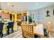 Well-lit dining area with a table for six, seamlessly connecting to the kitchen area at 6322 Highledge St, North Las Vegas, NV 89081