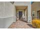 Inviting front porch featuring brick flooring and seating area at 6322 Highledge St, North Las Vegas, NV 89081