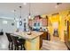 Bright kitchen featuring granite countertops, stainless steel appliances, and a breakfast bar with seating at 6322 Highledge St, North Las Vegas, NV 89081