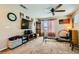 Cozy living room featuring a ceiling fan, TV, and comfortable seating area at 6322 Highledge St, North Las Vegas, NV 89081