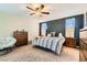 Spacious main bedroom features a ceiling fan and a large bed at 6322 Highledge St, North Las Vegas, NV 89081