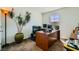 Well-lit home office features large desk space, filing cabinet, and potted plant, ideal for remote work at 6322 Highledge St, North Las Vegas, NV 89081