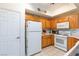Bright kitchen with oak cabinets, white appliances, and ample counter space at 5855 Valley Dr # 1028, North Las Vegas, NV 89031