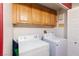 Laundry room with washer, dryer, and wooden cabinets at 5855 Valley Dr # 1028, North Las Vegas, NV 89031