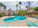 Freeform community pool with lounge chairs at 5855 Valley Dr # 1028, North Las Vegas, NV 89031