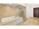 Bathroom featuring a large tub, separate glass shower, and tile flooring at 9101 Alta Dr # 1202, Las Vegas, NV 89145