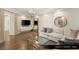 Gathering room/den with hardwood floors, couch, television, and coffee table at 9101 Alta Dr # 1202, Las Vegas, NV 89145