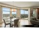 Dining area featuring a modern chandelier, glass table, and balcony access with city views at 9101 Alta Dr # 1202, Las Vegas, NV 89145