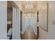 Long hallway featuring elegant lighting, beautiful wall decor, and hardwood flooring at 9101 Alta Dr # 1202, Las Vegas, NV 89145