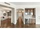 Hallway with hardwood floors, chandeliers, and a bar at 9101 Alta Dr # 1202, Las Vegas, NV 89145