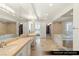 Primary bathroom with dual vanities, walk-in shower, soaking tub, and designer finishes at 9101 Alta Dr # 1202, Las Vegas, NV 89145