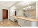 Luxurious bathroom featuring dual sinks, a walk-in shower, and a spacious walk-in closet at 9101 Alta Dr # 1202, Las Vegas, NV 89145