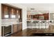 Wet bar with wine fridge, glassware, and modern finishes at 9101 Alta Dr # 1202, Las Vegas, NV 89145