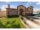 Two story house with tile roof, three car garage and landscaped yard at 8713 W Gilmore Ave, Las Vegas, NV 89129