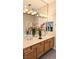 Bathroom featuring double sinks, modern lighting, and wood cabinets at 9809 Miss Peach Ave, Las Vegas, NV 89145