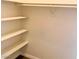 Empty walk-in closet with built in shelving at 9809 Miss Peach Ave, Las Vegas, NV 89145