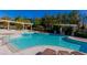 Beautiful community pool and lounge area with sun loungers at 9809 Miss Peach Ave, Las Vegas, NV 89145