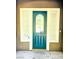 Home featuring a teal front door with decorative glass and sidelight windows at 9809 Miss Peach Ave, Las Vegas, NV 89145