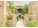 Exterior view of the front of the home with gate, manicured shrubs, and trees at 9809 Miss Peach Ave, Las Vegas, NV 89145