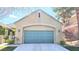 Front exterior of a single-story house featuring a two-car garage with a driveway at 9809 Miss Peach Ave, Las Vegas, NV 89145