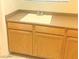 This laundry room includes a sink and cabinets at 9809 Miss Peach Ave, Las Vegas, NV 89145