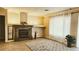 Bright living room with hard wood floors, fireplace, and large bright windows at 9809 Miss Peach Ave, Las Vegas, NV 89145