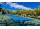 Blue community tennis court surrounded by trees at 9809 Miss Peach Ave, Las Vegas, NV 89145