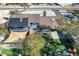Aerial view of backyard, patio, and manicured lawn with fire pit and mature trees at 7135 Polaris Ave, Las Vegas, NV 89118