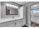 Bathroom features an elongated vanity with storage and a shower/tub combo at 7135 Polaris Ave, Las Vegas, NV 89118