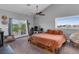 Bright bedroom with a ceiling fan, carpeted floors, and access to a balcony at 7135 Polaris Ave, Las Vegas, NV 89118
